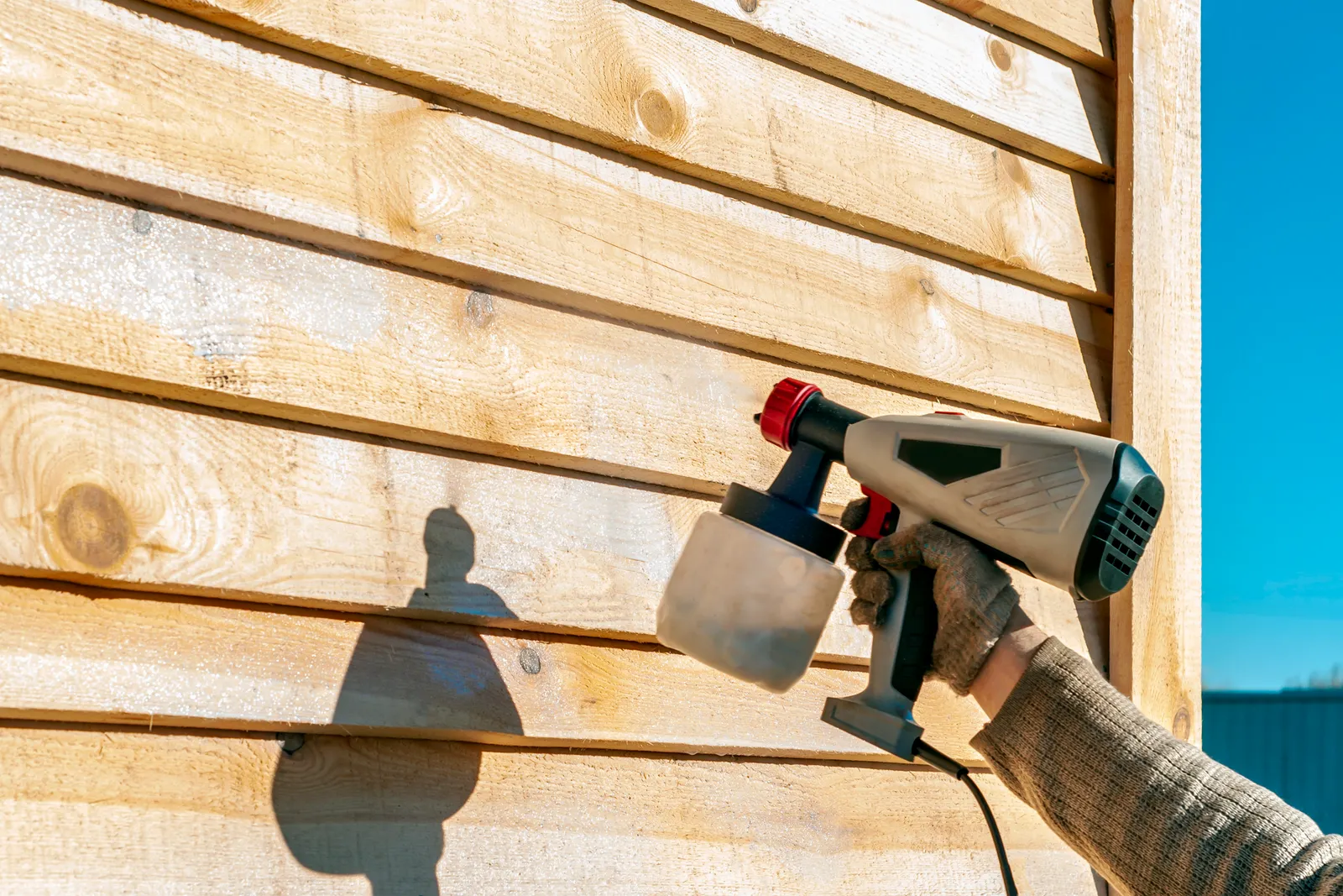 Timber being treated with a preservative spray